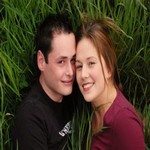 794580_young_couple_kissing_in_the_gras
