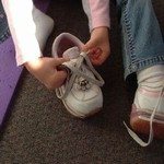 413151_girl_tying_shoe