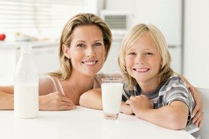 Smiling Mother and Son Posing with Milk