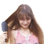 Young girl brushing her long dark hair